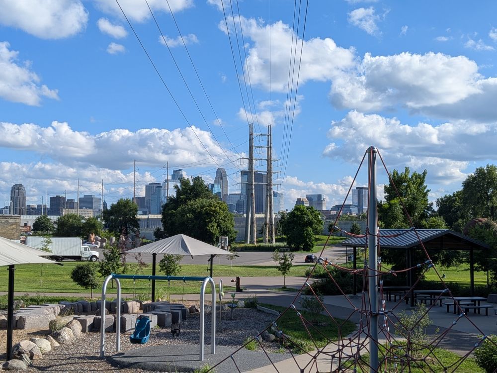 Play structures with the Minneapolis skyline in the distance. 