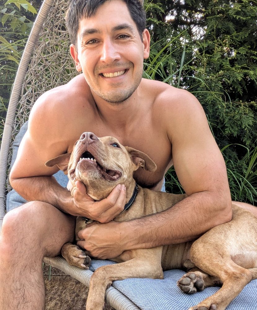 thirty six year old man holding his ten year old red nose pittie 