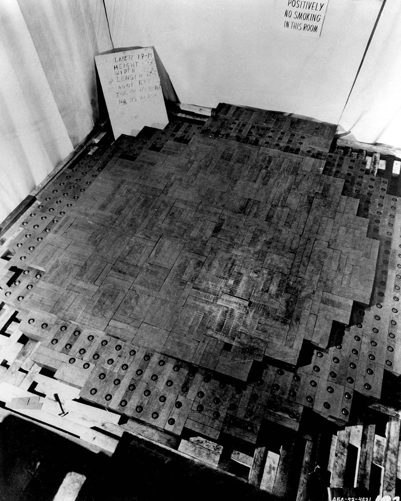A partially stacked set of graphite bricks with uranium spheres in little holes in the middle of some, as CP-1 was being built.
