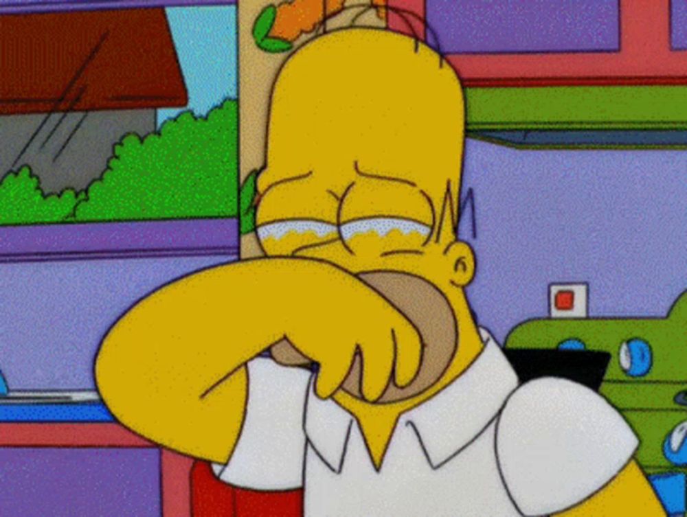 a cartoon of homer simpson crying with his hand on his face