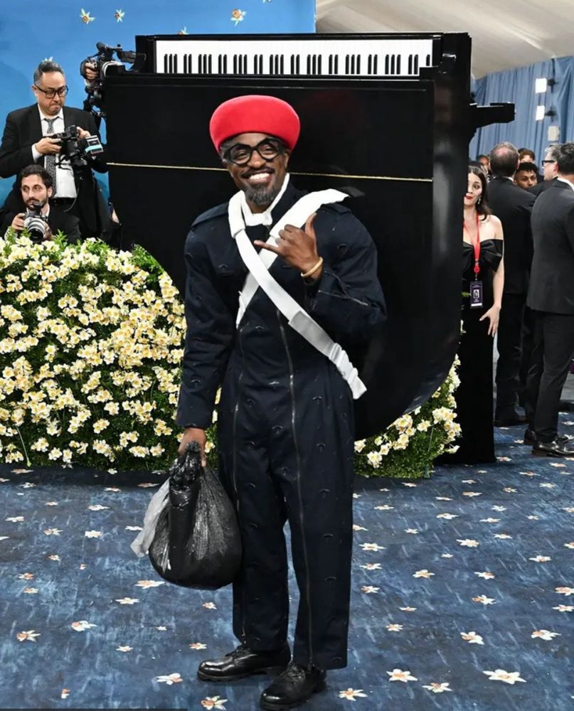Andre 3000 at the met gala he has a piano on his back 