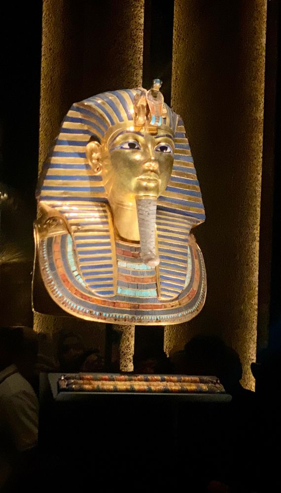 A photo of Tutankhamens mask. It’s made of gold with a face on it 