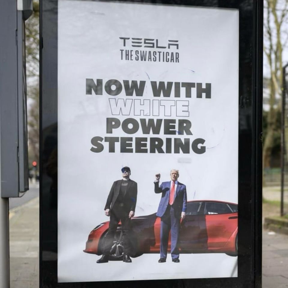 A bus shelter advert Tesla THE SWASTICAR NOW WITH WHITE POWER STEERING picture of trump and musk and a Tesla 