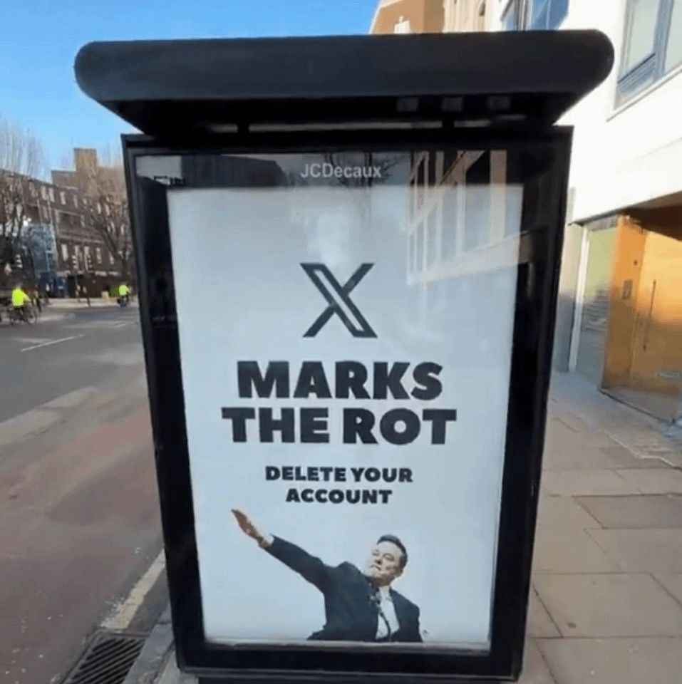 A bus stop shelter the advert is c marks the rot delete your account with Elon musk doing the Nazi salute 