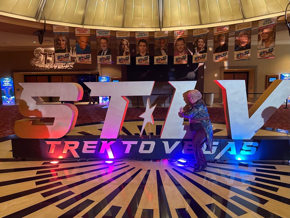 Tracey as his Ferengi character Pek coveting the STLV sign