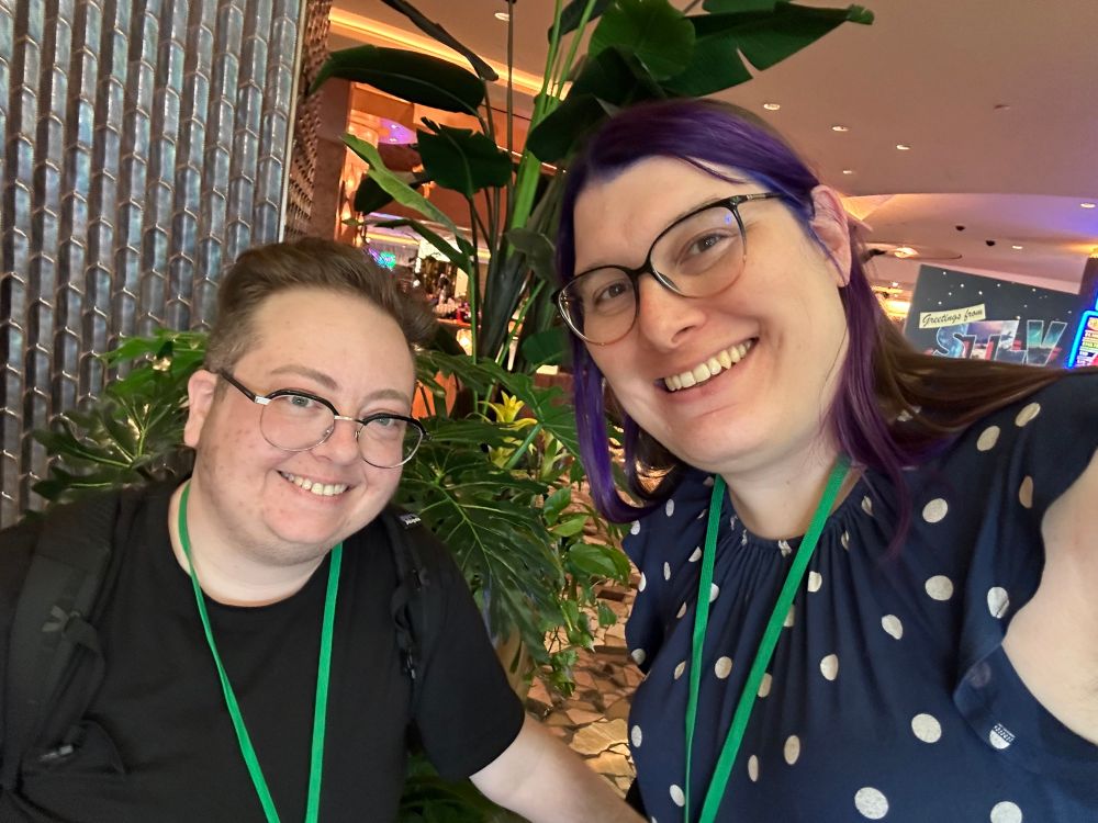 A selfie of me and Tracey in front of some plants near the main entrance of the Rio