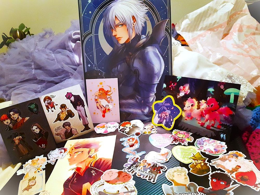 Various pieces of art prints, stickers and embroidered patches are displayed  