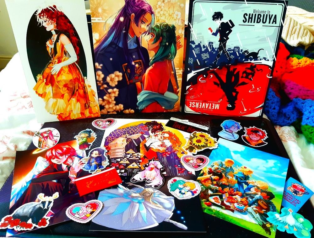 a collection of art prints and stickers laid out 