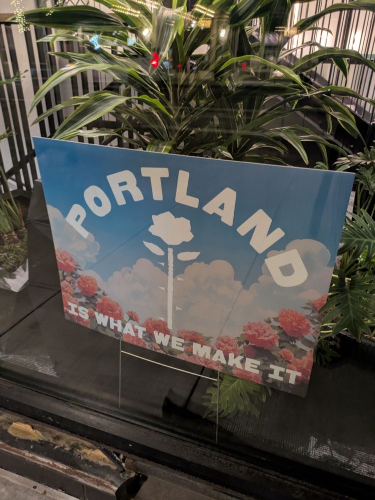 A sign of Portland is what we make it on a blue sky with clouds and roses.  