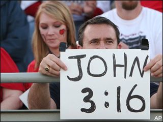 Football fan holding up sign: “John 3:16”