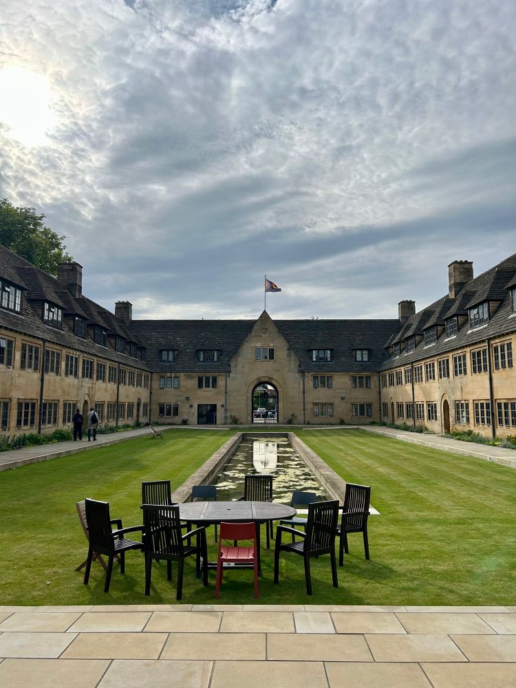 Picture of rectangular courtyard with pond, surrounded by stone building.