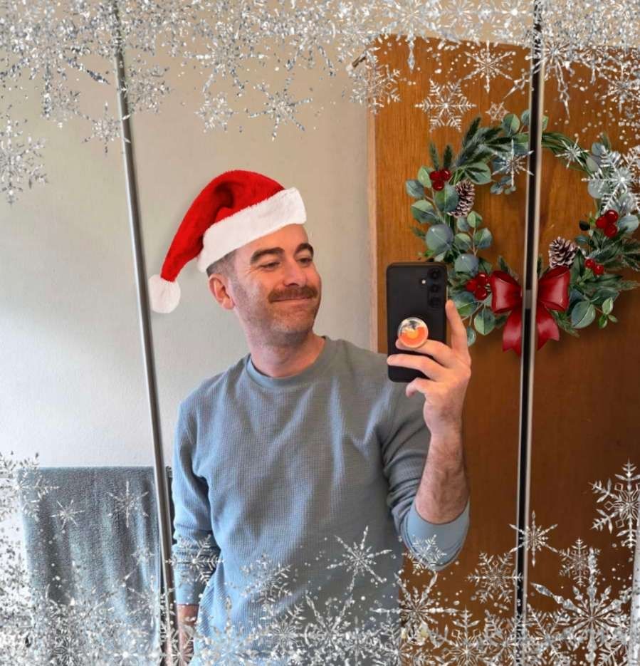 Mirror pic of me with frost and a Santa hat added in, and a wreath on the door for Christmas 