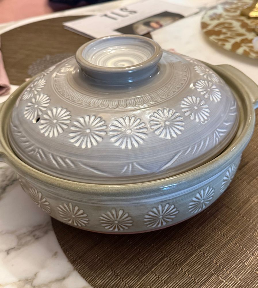 A donabe, Japanese earthenware pot. Round, with lid, rather like a Dutch oven. Grey, chrysanthemum design 