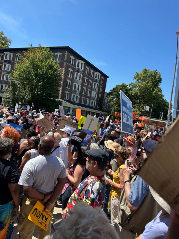 Hundreds of rally goers spill into the street on sunny day in Philadelphia. 