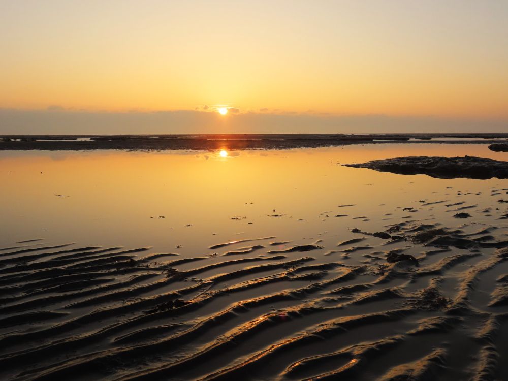 Reflection and patterns at sunrise on Greatstone beach this morning.