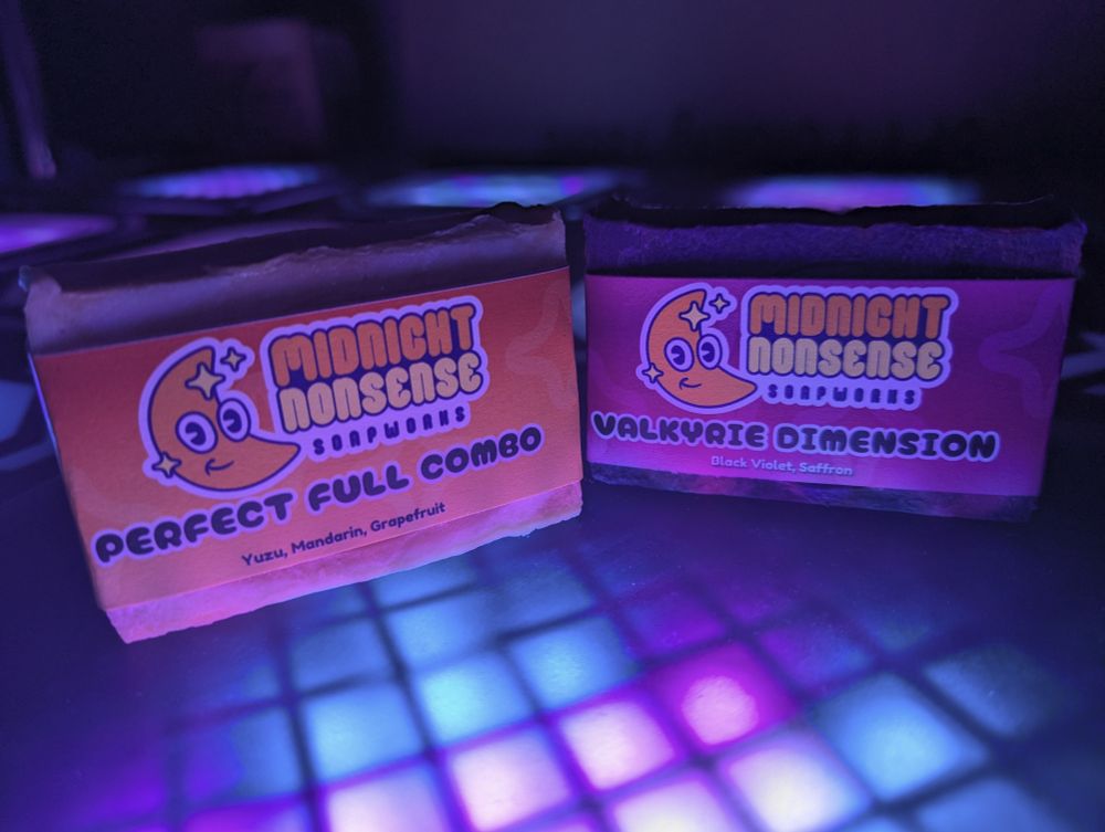 Two colorful soaps atop a bright dance stage tile