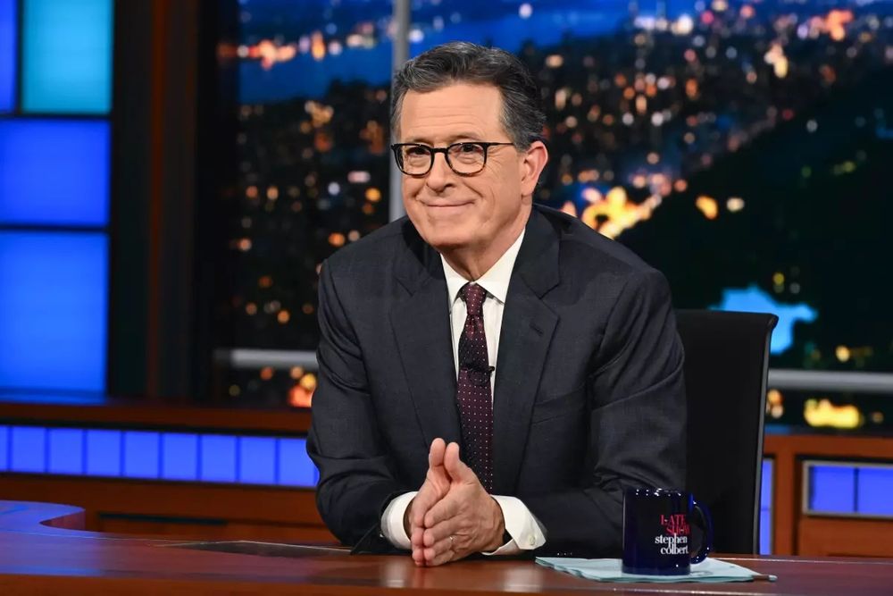 Stephen Colbert at his desk of the CBS Late Night Show.