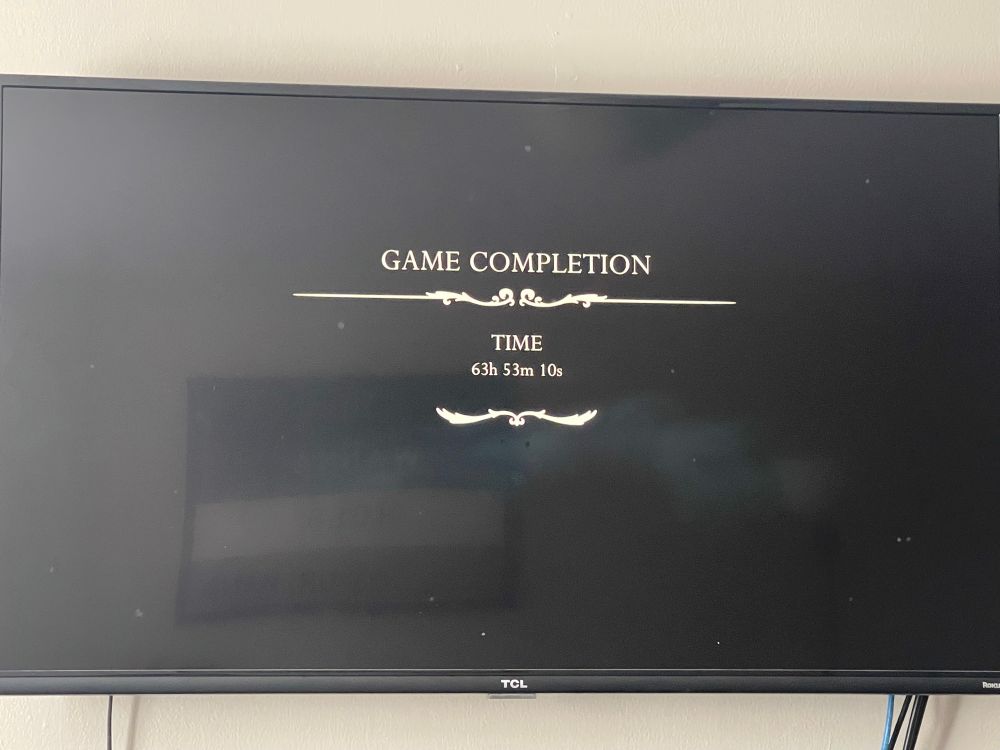 A black tv screen with white text saying “Game Completion, Time sixty-three hours, fifty-three minutes, ten seconds from the game Silksong