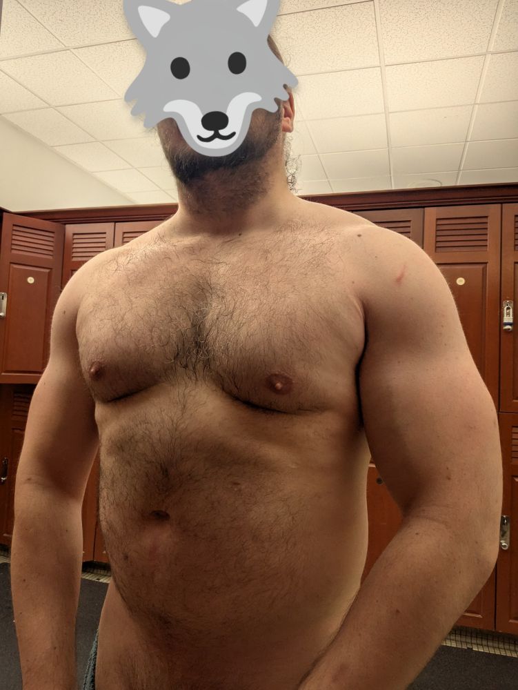Me standing in a locker room, mostly nude. A wolf emoji (🐺) obscures my face, and the cropping of the image excluded my groin. I still consider this NSFW even though it's not actually showing my junk, because it's the sort of thing that I think people wouldn't want to be seen as having on their phone at work or in a public place.