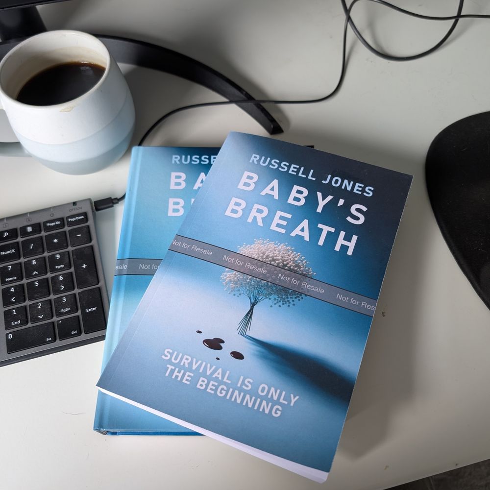 Hardback and Paperback copies of Baby's Breath on my desk
