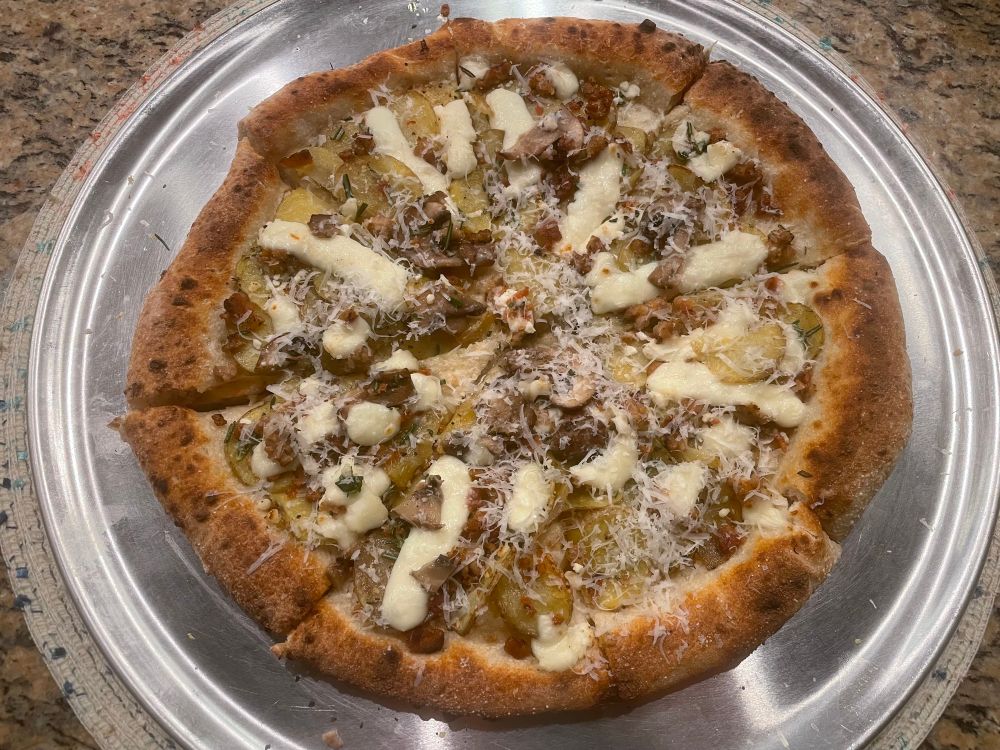 Pizza with potato, mushrooms, and mozzarella.