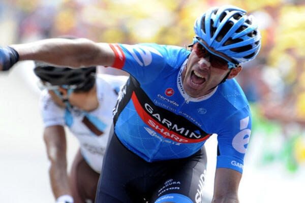 David Millar, in the blue kit of Garmin Sharp, punches the air as he crosses the line to take a victory 