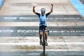 Lizzie Deignan raises her arms in celebration as she crosses the line in the Roubaix velodrome