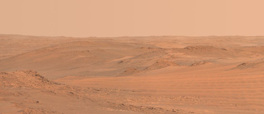 A distant desert landscape of buttes, sand dunes, and rocky hillsides.

NASA/JPL-Caltech/ASU/Kevin M. Gill