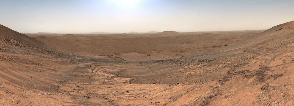 Rocks and sand out to the horizon. 

NASA/JPL-Caltech/ASU/Kevin M. Gill