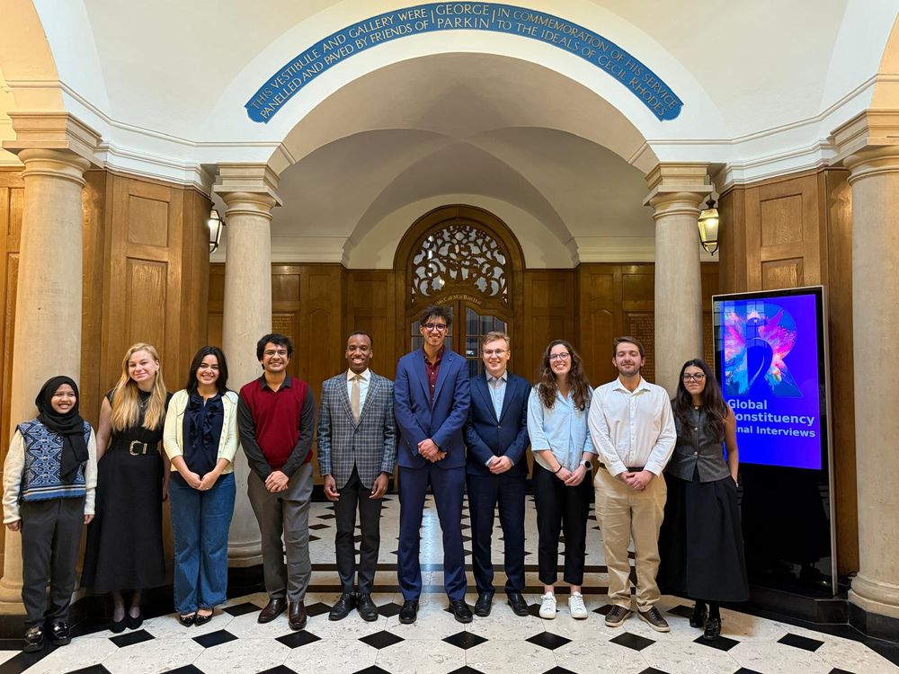 10 finalists standing in a row in the Parkin Vestibule in Rhodes House.