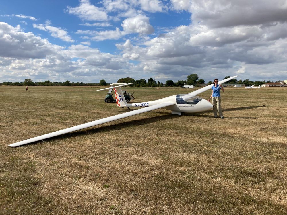 Siobhan standing next to a glider plane