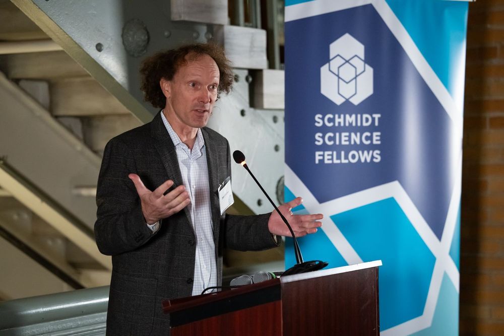Dan Fletcher speaks in front of a banner that reads Schmidt Science Fellows