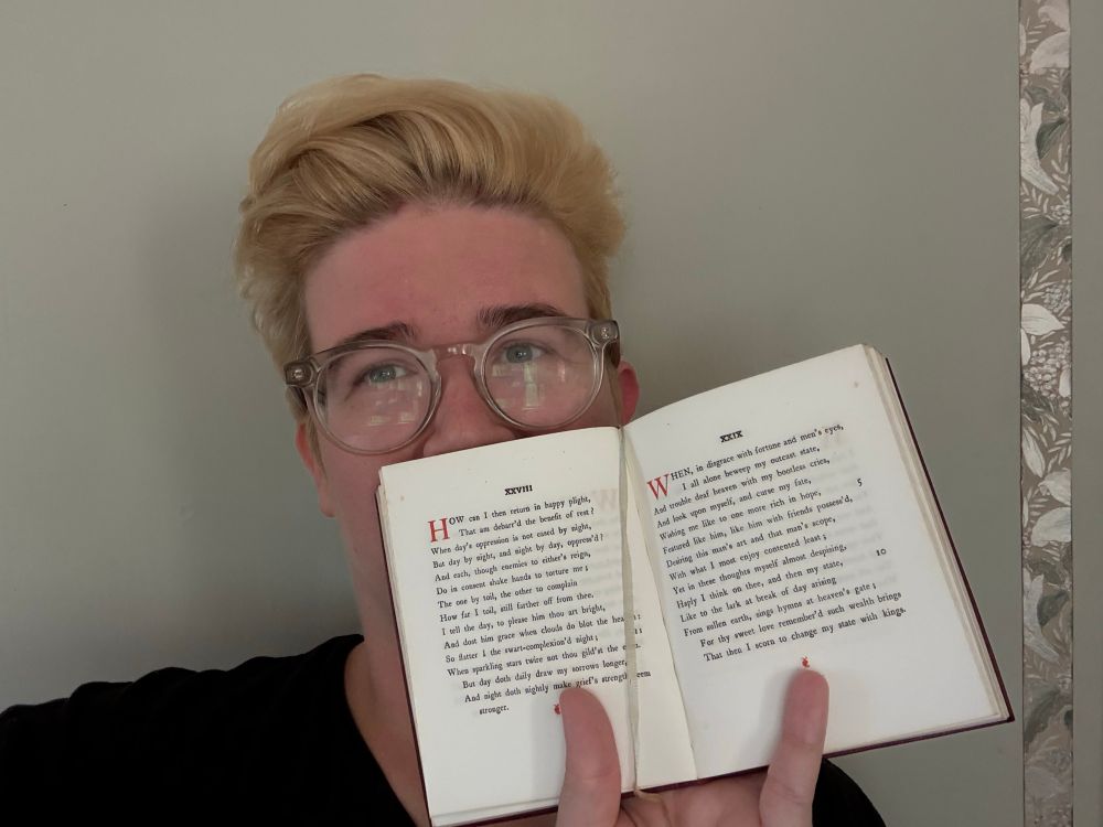 a selfie with Aud holding a Temple Shakespeare edition of the sonnets by William Shakespeare 