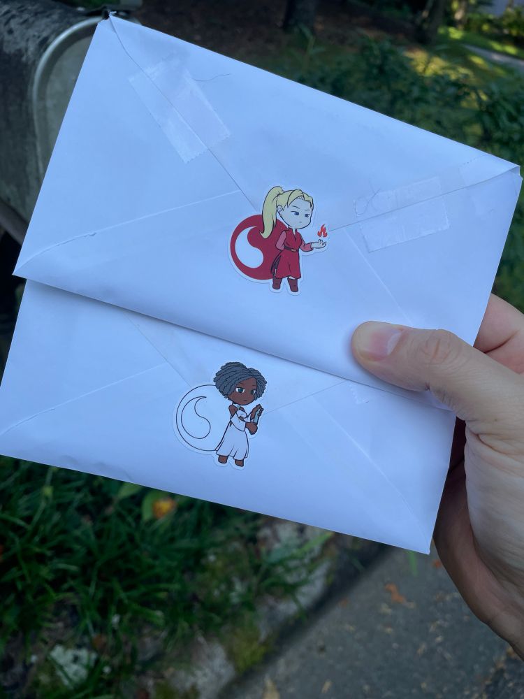 The back of the envelopes. They are sealed with stickers of little aes sedai. One is from the red ajah the other is from the white ajah. 