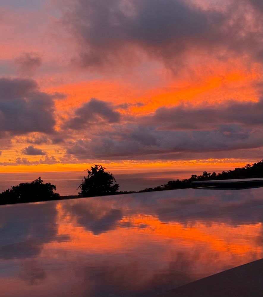 Orange sky at the end of the sunset over the pool. 