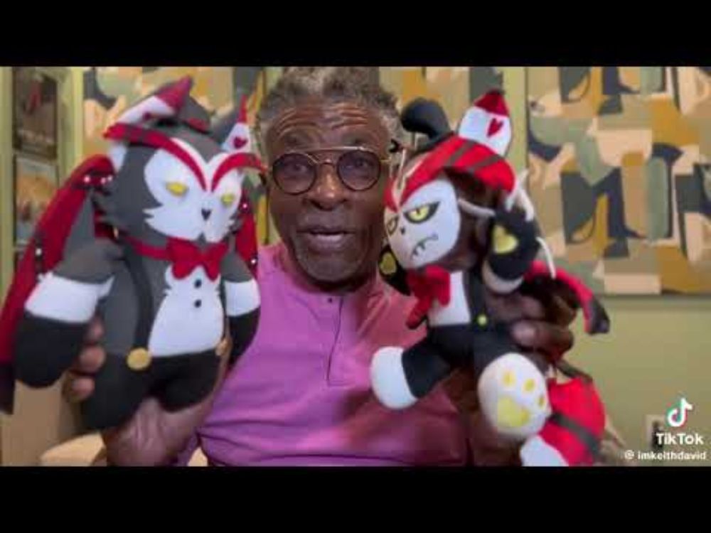 Keith David playing with his husk plushies