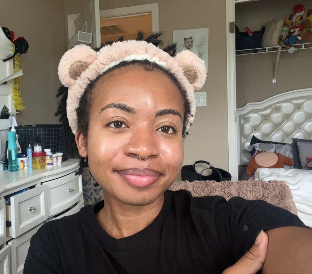 Elijah smiling, he’s wearing a bear ears headband used to keep hair out of his face