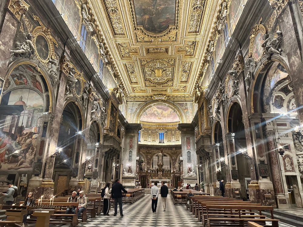 The central nave of Santissima Annunziata, brilliantly glittering with lights, gold, silver, frescos, and paintings 
