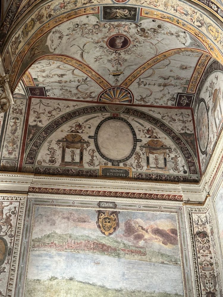 Details of arched ceiling above a painted wall panel depicting the (very not Italian) city of Stein