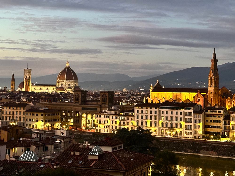 A last view of Florence as the sky darkens after sunset and the city lights come up