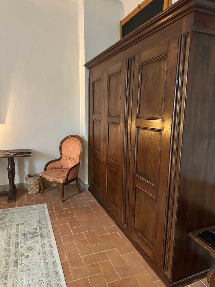 Wooden wardrobe and an antique looking chair 