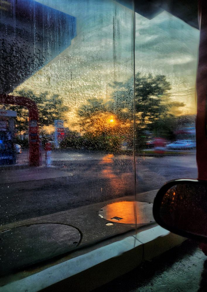 The view of a sunset out of a driver's side window at a car wash in Scarborough Ontario 
