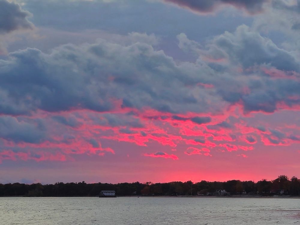The set sun reflects off of clouds over Point Abino in Fort Erie Ontario 