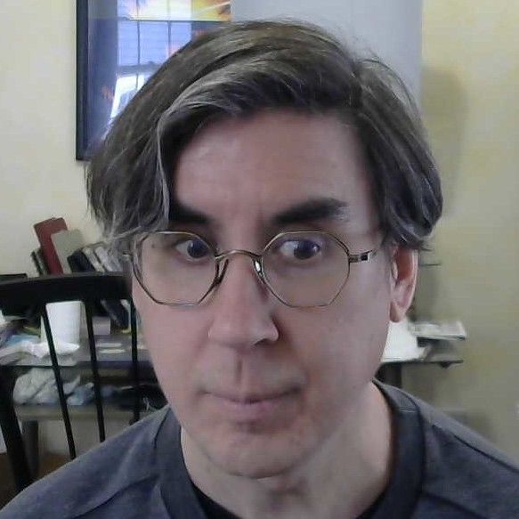 A photo of me with some new brassy octagonal glasses