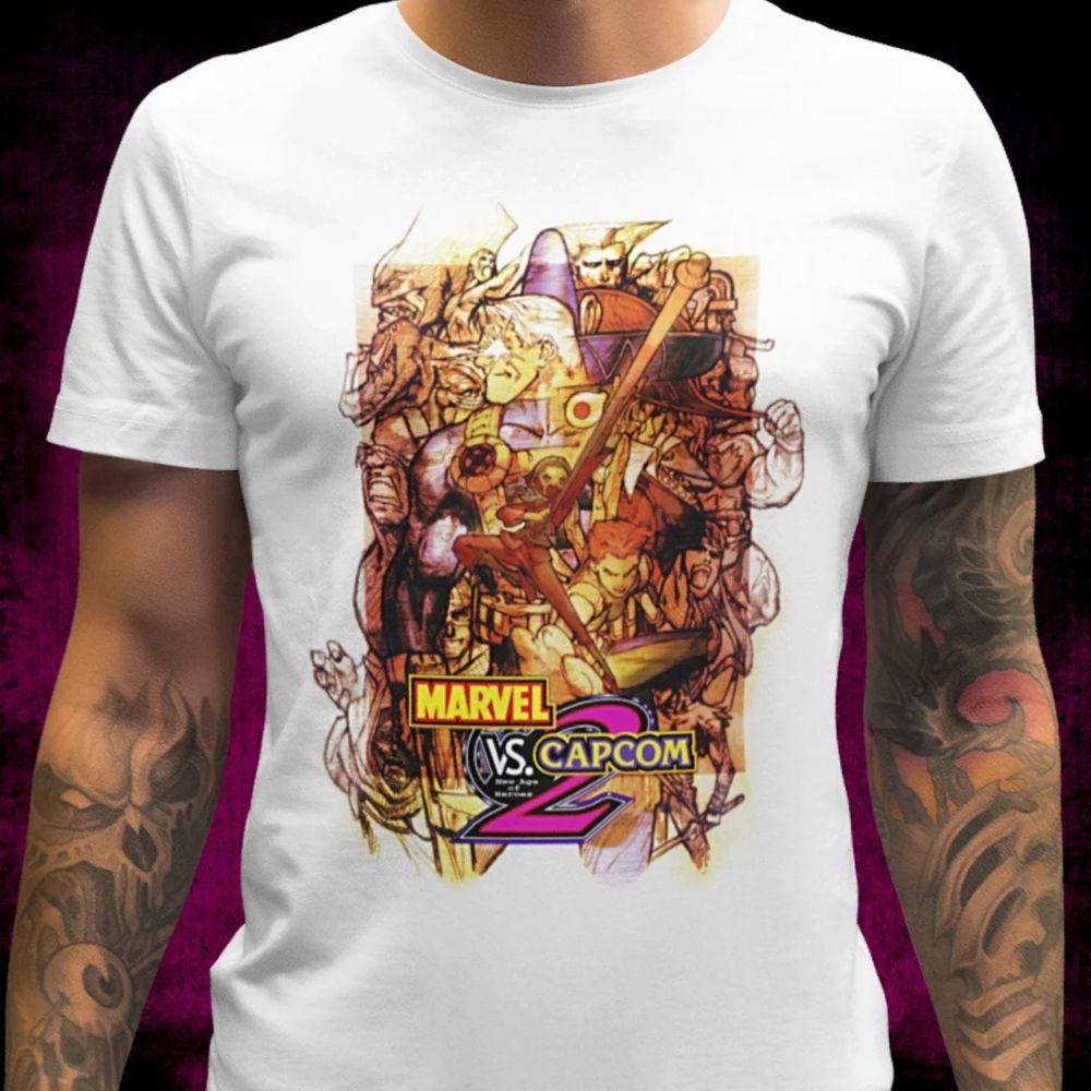 A man wearing a T-shirt with the Japanese box aet of Marvel vs. Capcom 2 printed on it.