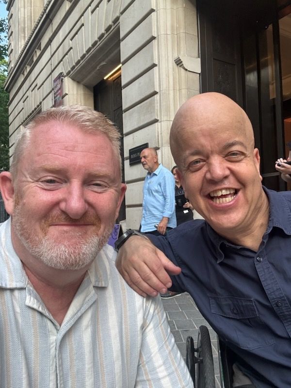 Two white men about 60 years old, one bearded ^ one bald, both beaming.