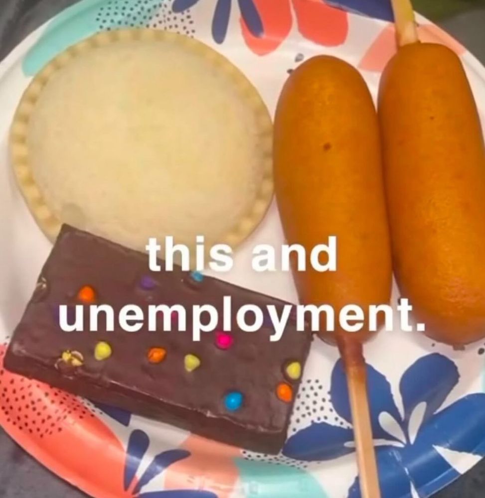 A picture of a plate of food. The food being a cosmic brownie, an uncrustable, and two corn dogs. The caption reads: “This and unemployment”