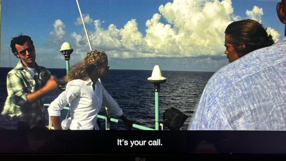Justin Theroux in a green plaid shirt on a boat in Michael Mann’s Miami Vice.