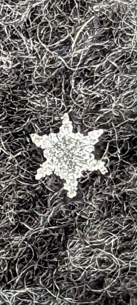 Closeup of a star shaped snowflake on wool