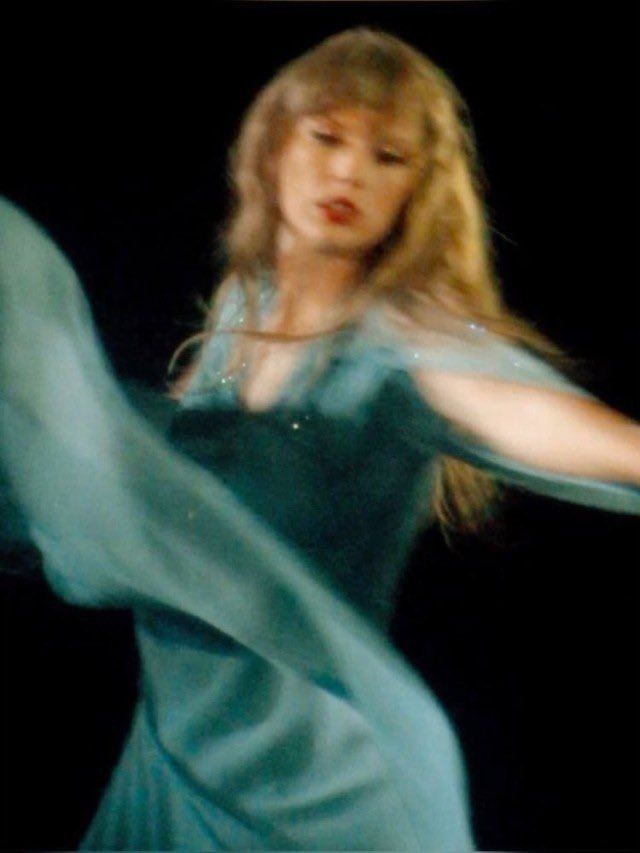 Taylor swift on stage at the eras tour during folklore era